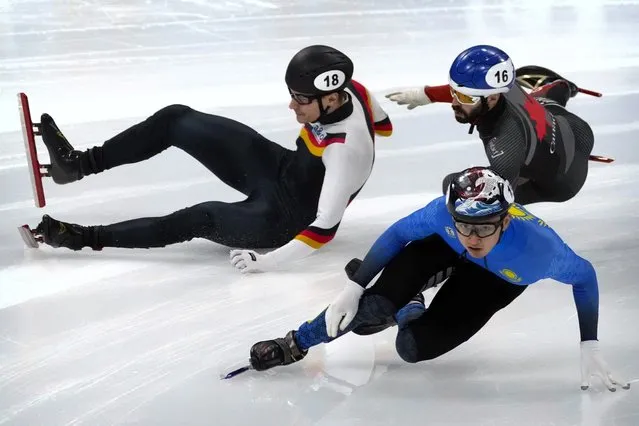 Christoph Schubert of Germany, left, and Steven Dubois of Canada fall while competing in a preliminary of the men's 1000m at the ISU World Cup Short Track speed skating competition, a test event for the 2022 Winter Olympics, at the Capital Indoor Stadium in Beijing, Friday, October 22, 2021. (Photo by Mark Schiefelbein/AP Photo)