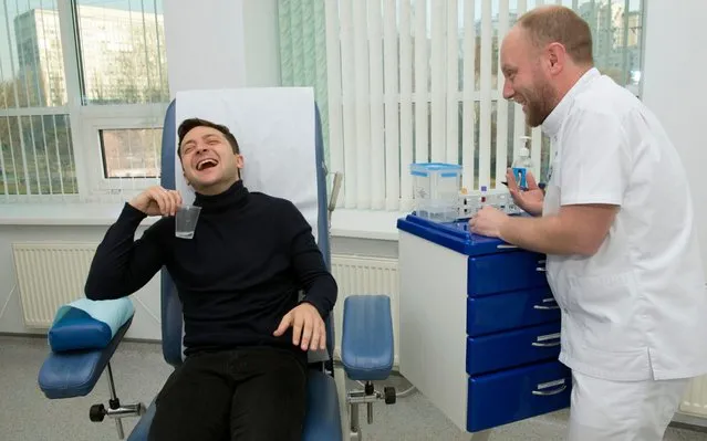 Volodymyr Zelenskiy, a popular comedian who left Ukraine's President Petro Poroshenko far behind in Sunday's presidential elections first round, laughs as he takes a blood test in Kiev, Ukraine, Friday, April 5, 2019. Ukraine's presidential candidates have taken alcohol and drug tests before a runoff vote on April 21. (Photo by Soya Shu/AP Photo)
