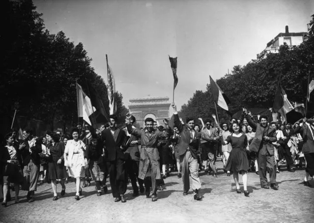 8th May 1945: Crowds on the Champs Elysees celebrate Victory in Europe at the end of World War II with a joyful procession. (Photo by Keystone/Getty Images)