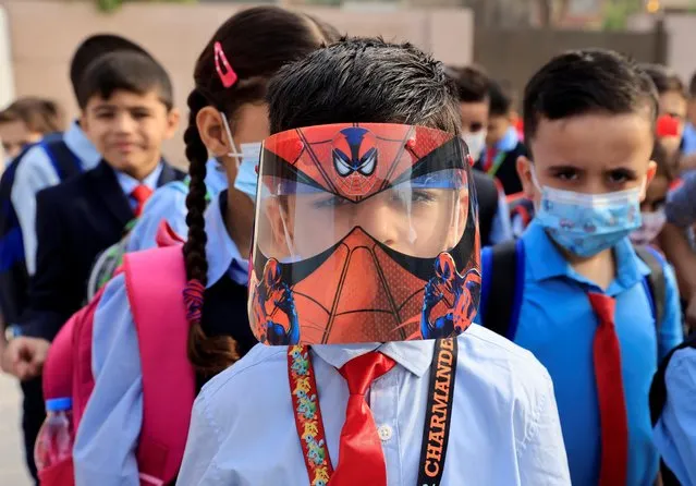 A student wears a Spider-Man face shield on the first day of the new term at a primary school in Baghdad, Iraq on November 1, 2021. (Photo by Thaier Al-Sudani/Reuters)