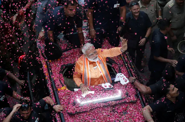 India's Prime Minister Narendra Modi waves towards his supporters during a roadshow in Varanasi, India, April 25, 2019. (Photo by Adnan Abidi/Reuters)