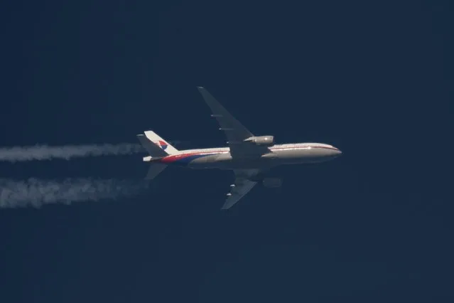 Malaysia Airlines Boeing 777 plane with registration number 9M-MRO flies over Poland in this February 5, 2014 file photo. (Photo by Tomasz Bartkowiak/Reuters)