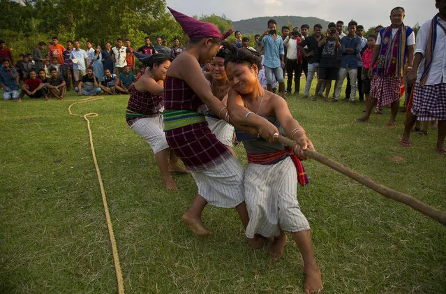 In this Monday, June 10, 2019 photo, Indian Rabha tribal Hindu women participate in tug of war during Baikho festival at Pantan village, west of Gauhati, India. (Photo by Anupam Nath/AP Photo)