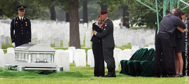 Family and friends console each other during the burial service for U.S. Army Sergeant Chad Keith at Arlington National Cemetery