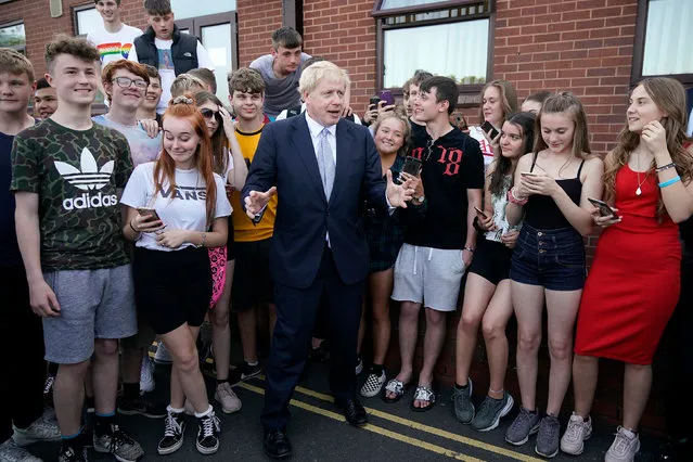 Boris Johnson, leadership candidate for Britain's Conservative Party poses for a photgraph with local teenagers after a campaign event Wombourne Civic Hall on June 28, 2019 in Wombourne, United Kingdom. (Photo by Christopher Furlong – WPA Pool/Getty Images)