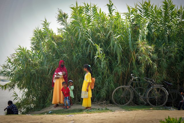 A woman with her children waits for boat to leave after casting her vote in a polling station on the banks of the Brahmaputra river during the second round of voting in the six-week-long national election in Morigaon district, Assam, India, Friday, April 26, 2024. (Photo by Anupam Nath/AP Photo)