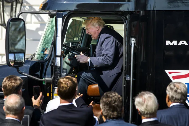 US President Donald J. Trump gets in the driver's seat of an 18-wheeler while meeting with truck drivers and trucking CEOs on the South Portico prior to their meeting to discuss health care at the White House in Washington, DC, USA, 23 March 2017.  The House of Representatives has yet to vote on the Republican-crafted American Health Care Act, that would replace the Affordable Care Act, as it remained unclear whether Republicans had enough votes to overcome opposition from Democrats and those within their own party. (Photo by Jim Lo Scalzo/EPA)