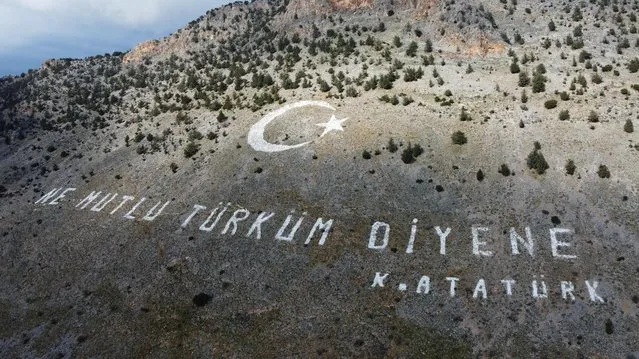 An aerial picture shows a quote by Turkish Republic founder Mustafa Kemal Ataturk, reading in Turkish: “Happy are they who call themselves a Turk”, painted on the Kyrenia mountain range north of the divided Cypriot capital Nicosia, in the territory held by the TRNC, on January 22, 2022. Turkish Cypriots are to cast their ballots on January 23, for a snap legislative election in the breakaway northern third of the Mediterranean island after a campaign dominated by an economic crisis. (Photo by AFP Photo/Stringer)