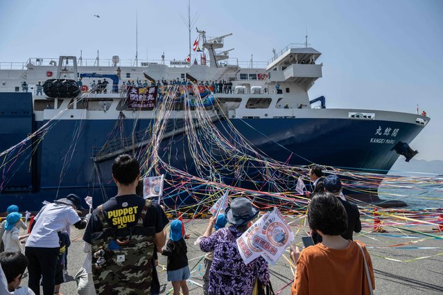 People see off Japan's new whaling mothership, the Kangei Maru, after the ship's launch ceremony at a port in Shimonoseki city, Yamaguchi prefecture on May 21, 2024. The nearly 9,300-tonne ship set sail on its maiden hunting voyage on May 21, heralding a new era for the controversial practice defended by the government as an integral part of national culture. (Photo by Yuichi Yamazaki/AFP Photo)
