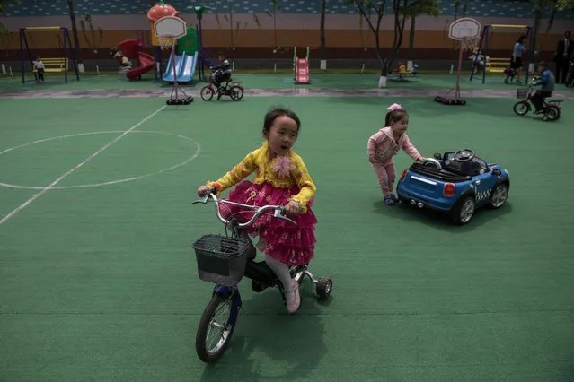 Children play at a day care centre for children of workers at a silk factory in Pyongyang on May 9, 2016. (Photo by Ed Jones/AFP Photo)