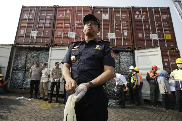 Director General of Indonesian Customs and Excise Heru Pambudi speaks to the press near containers full of plastic waste at Tanjung Priok port in Jakarta, Indonesia Wednesday, September 18, 2019. Indonesia is sending hundreds of containers of waste back to Western nations after finding they were contaminated with used plastic and hazardous materials. (Photo by Achmad Ibrahim/AP Photo)