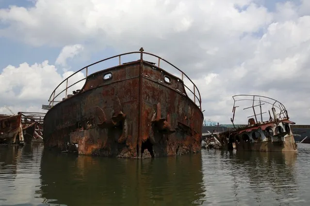 Decayed and partly submerged ferries, tugs and military vessels are seen during the “Graveyard of Ships” kayak tour on the Arthur Kill, New York July 7, 2015. (Photo by Shannon Stapleton/Reuters)