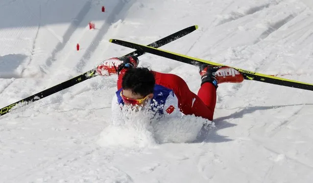 Chinas Liu Xiaobin falls after the finish line during the mens middle distance free technique standing para cross-country skiing event on March 12, 2022, at the Zhangjiakou National Biathlon Centre during the Beijing 2022 Winter Paralympic Games. (Photo by Issei Kato/Reuters)