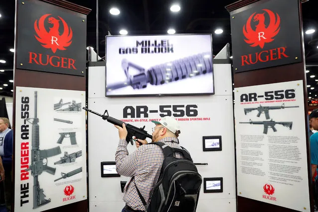 Attendees visit the trade booths during the National Rifle Association's annual meeting in Louisville, Kentucky, May 21, 2016. (Photo by Aaron P. Bernstein/Reuters)