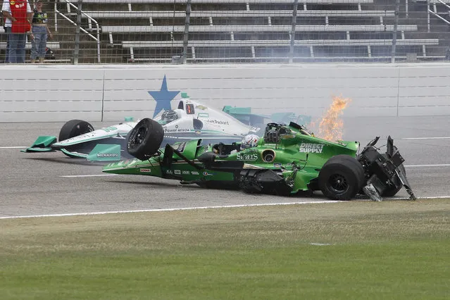 Josef Newgarden's car rolls to the upright position after being involved in a wreck with Conor Daly during an IndyCar auto race at Texas Motor Speedway, June 12, 2016, in Fort Worth, Texas. (Photo by Tim Sharp/AP Photo)