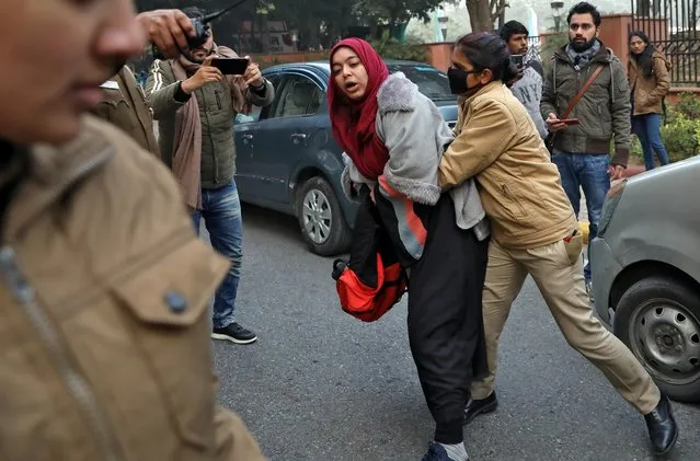 A policewoman tries to detain a demonstrator during a protest against a new citizenship law, in New Delhi, India, December 27, 2019. (Photo by Anushree Fadnavis/Reuters)