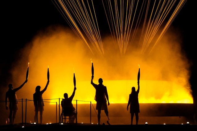 Torchbearers Charles Antoine Kouakou, Fabien Lamirault, Elodie Lorandi, Nantenin Keita and Alexis Hanquinquant gesture after lighting the Cauldron to conclude the opening ceremony of the Paris 2024 Summer Paralympic Games at Place de la Concorde on August 28, 2024 in Paris, France. (Photo by David Ramos/Getty Images)