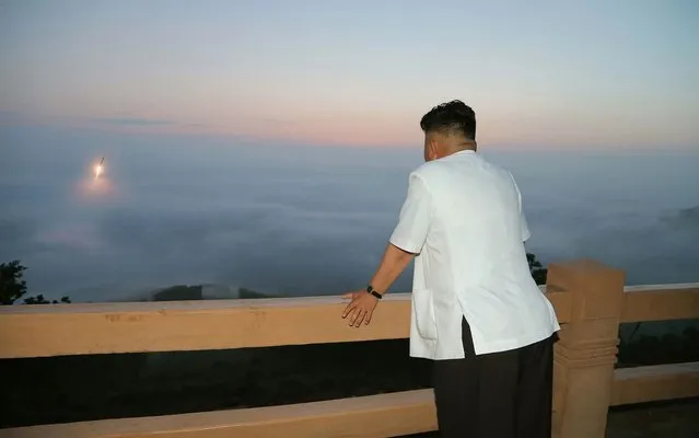 This undated picture released from North Korea's official Korean Central News Agency on June 30, 2014 shows North Korean leader Kim Jong-Un inspecting a tactical rocket firing drill by the Korean People's Army Strategic Force at an undisclosed place in North Korea. (Photo by AFP Photo/KCNA via KNS)