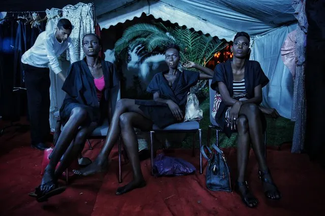 Models sit backstage during Dakar Fashion Week in the Senegalese capital, Friday June 30, 2017. The continent's fashion scene has grown steadily over the past two decades with Sub-Saharan Africa's apparel and footwear market now worth $31 billion, according to data by Euromonitor. (Photo by Finbarr O'Reilly/AP Photo)