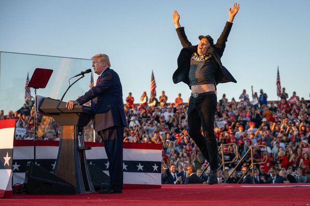 Tesla CEO Elon Musk (R) jumps on stage as he joins former US President and Republican presidential candidate Donald Trump during a campaign rally at site of his first assassination attempt in Butler, Pennsylvania on October 5, 2024. (Photo by Jim Watson/AFP Photo)