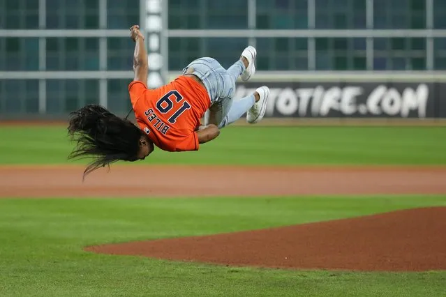 Olympic gymnastics gold medalist and Houston native Simone Biles performs a flip before throwing out a ceremonial first pitch prior to game two of the World Series between the Houston Astros and the Washington Nationals at Minute Maid Park in Houston on October 23, 2019. (Photo by Troy Taormina/USA TODAY Sports)