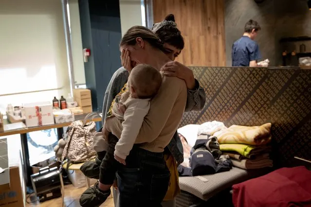 Anna Zaitseva, with her six-month-old baby Svait, is comforted by friend Vlada (right), as the two university friends reunite following Anna and Svait’s evacuation from the Azovstal steel factory in the Russian-controlled city of Mariupol, as seen at a reception center for internally displaced people, as seen on Tuesday, May 3, 2022 in Zaporizhzhia, Ukraine. According to the United Nations Humanitarian Coordinator in Ukraine, Osnat Lubrani, 101 people arrived in a humanitarian convoy from Mariupol on Tuesday. (Photo by Nicole Tung/The Washington Post)