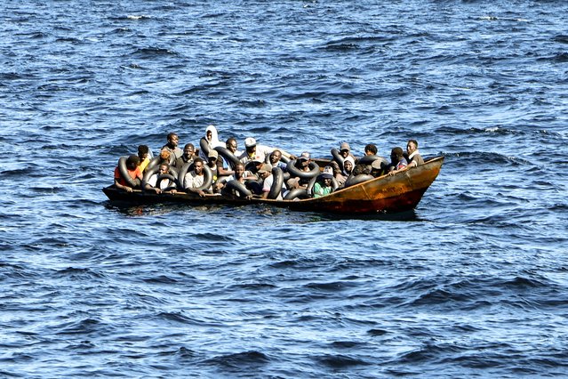 Migrants of African origin trying to flee to Europe are crammed on board of a small boat, as Tunisian coast guards prepare to transfer them onto their vessel, at sea between Tunisia and Italy, on August 10, 2023. Mediterranean Sea crossing attempts from Tunisia have multiplied following a incendiary speech by the Tunisian president who had alleged that “hordes” of irregular migrants were causing crime and posing a demographic threat to the mainly Arab country. (Photo by Fethi Belaid/AFP Photo)