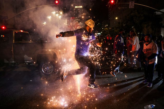 A Dodgers fan celebrates on the street after the Los Angeles Dodgers' victory over the New York Yankees to win the World Series in Los Angeles, California on October 31, 2024. (Photo by Daniel Cole/Reuters)