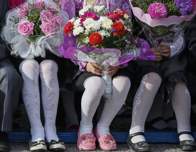First graders attend a festive ceremony to mark the start of another school year in Slaviansk, September 1, 2014. (Photo by Gleb Garanich/Reuters)