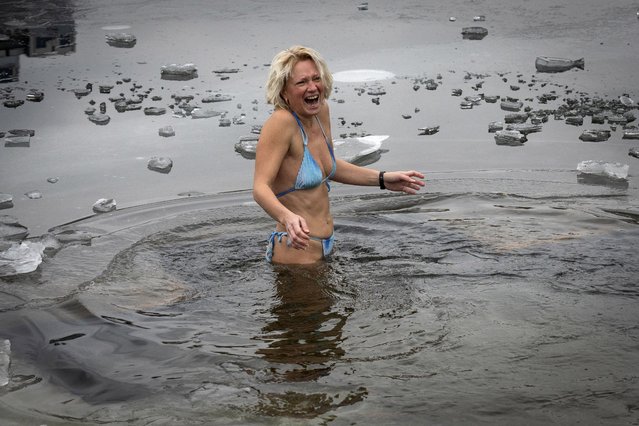 An Orthodox believer dips into icy water during celebrations of Epiphany in Kyiv, Ukraine, Monday, January 6, 2025. (Photo by Efrem Lukatsky/AP Photo)