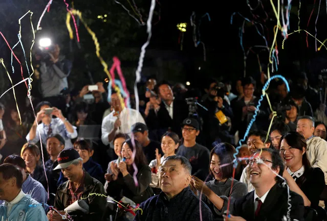 Fans of the Japanese writer Haruki Murakami celebrate after they heard that Japanese-born Kazuo Ishiguro won the Nobel Prize for Literature while they gather in a shrine with the hope of celebrating Murakami's winning in the prize in Tokyo, Japan, October 5, 2017. (Photo by Kim Kyung-Hoon/Reuters)