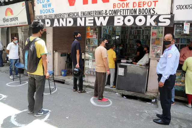 People queue outside a book store after a book market opens amid the nationwide coronavirus lockdown in Jammu, India, 30 April 2020. Jammu and Kashmir administration allowed the opening of some business activities in urban areas of Jammu region on 29 April, after 35 days of coronavirus lockdown. India's initial 21-day lockdown was extended until 03 May in a bid to curb the spread of the coronavirus. (Photo by Jaipal Singh/EPA/EFE)