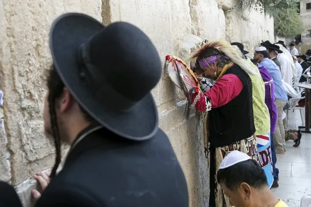 Jerry Aaronson (3rd L), a member of a First Nations Organisation, touches the stones of the Western Wall, Judaism's holiest prayer site in Jerusalem's Old City, September 13, 2015. (Photo by Baz Ratner/Reuters)