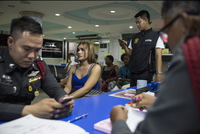A prostitute sits inside a police station after being arrested July 30, 2016 in Pattaya, Thailand. (Photo by Paula Bronstein/Getty Images)