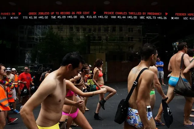 Sydneysiders take part in the “AIME Strut the Streets” in an attempt to break the Guiness record for the world's largest swimwear parade on December 7, 2012 in Sydney, Australia. The event was organised to raise funds and awareness for the not for profit charity organisation, the Australian Indigenous Mentoring Experience.  (Photo by Lisa Maree Williams)