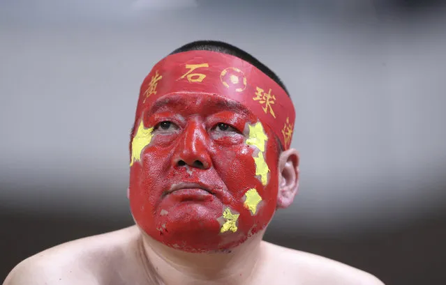 A supporter of the China national soccer team with his face painted in the China's national color during the soccer match against South Korea for the 2018 FIFA World Cup qualifier at Seoul World Cup Stadium in Seoul, South Korea, Thursday, September 1, 2016. (Photo by Lee Jin-man/AP Photo)