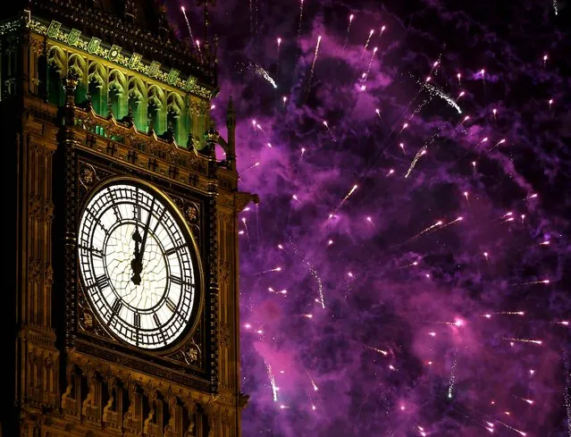 Fireworks explode over Elizabeth Tower housing the Big Ben clock in London. (Photo by Kirsty Wigglesworth/Associated Press)