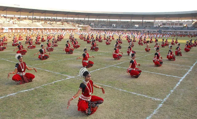 560 Indian Odissi dancers preform to try and get into the  Guinness Book of World Records during the inauguration of the International Odissi dance festival in Bhubaneswar on December 23, 2011. (Photo by STRDEL/AFP Photo)