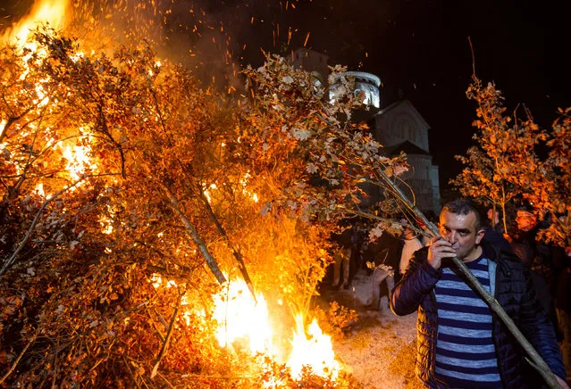 Believers burn dried oak branches, which symbolize the Yule log, on Orthodox Christmas Eve in Podgorica, Montenegro, January 6, 2018. (Photo by Stevo Vasiljevic/Reuters)