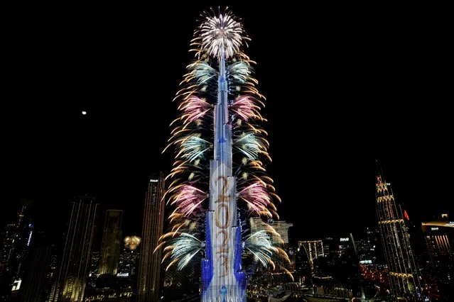 Fireworks explode at the Burj Khalifa, the world's tallest building, during the New Year's Eve celebration, in Dubai, United Arab Emirates, Sunday, January 1, 2023. (Photo by Kamran Jebreili/AP Photo)