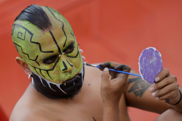 A participant applies his makeup in the Zócalo, the central square of Mexico City, Mexico on March 11, 2024, before assembling an offering and participating in a large-scale pre-Hispanic dance to celebrate the Aztec New Year. (Photo by Gerardo Vieyra/NurPhoto/Rex Features/Shutterstock)