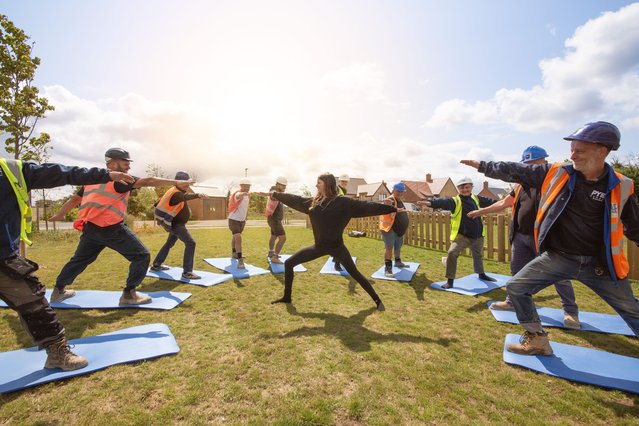 Builders working on Pye Homes’s Church Farm development in Radley, Oxfordshire, UK, take part in yoga classes on June 19, 2025 to help their mental health. (Photo by Emily Hall/Pye Homes)