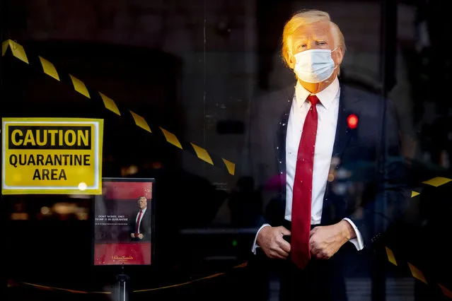 The wax figure of US President Donald Trump has also been “quarantined” at Madame Tussauds in Amsterdam, The Netherlands on October 3, 2020. The statue has a face mask in front of the window of Tussauds on the Dam. Trump and his wife Melania have tested positive for with the coronavirus and have gone into self-isolation at the White House. (Photo by Robin Utrecht/Rex Features/Shutterstock)