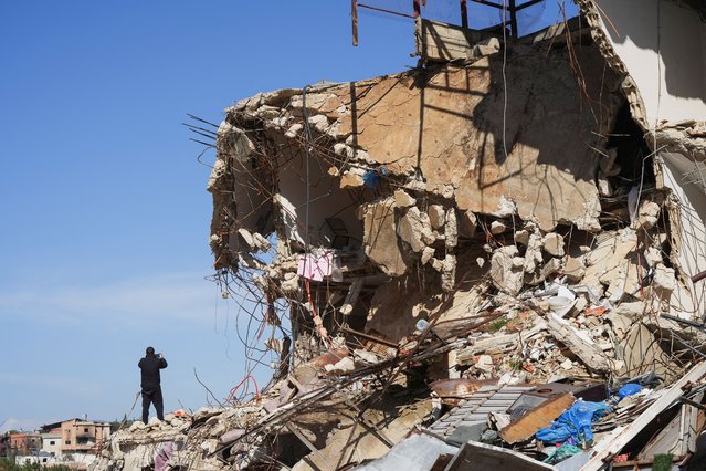A man stands next to a damaged building in the southern Lebanese village of Kfar Kila, after an Israeli military spokesperson said that Israel would keep troops in several posts in southern Lebanon past a February 18 deadline for them to withdraw, Lebanon on February 18, 2025. (Photo by Mohammed Yassin/Reuters)