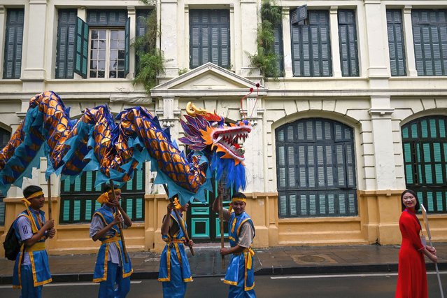 Vietnamese dragon dancers prepare to perform at the Hoan Kiem lake in Hanoi on October 3, 2020 as part of the city's preparation for a grand 1,010th anniversary celebration on October 10. (Photo by Manan Vatsyayana/AFP Photo)