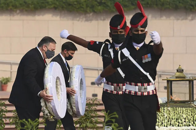 U.S. Secretary of State Mike Pompeo, left, and Secretary of Defence Mark Esper pay their tributes at the National War Memorial in New Delhi, India, Tuesday, October 27, 2020. In talks on Tuesday with their Indian counterparts, Pompeo and Esper are to sign an agreement expanding military satellite information sharing and highlight strategic cooperation between Washington and New Delhi with an eye toward countering China. (Photo by Jewel Samad/Pool via AP Photo)