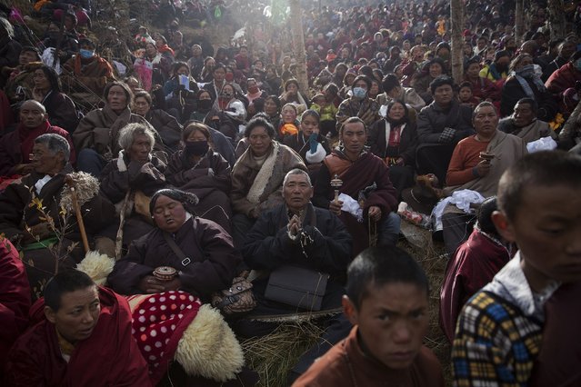 Ethnic Tibetan people pray on the hill above a Buddhist laymen lodge, where thousands of monks and nuns gather for morning chanting session, during the Utmost Bliss Dharma Assembly, the last of the four Dharma assemblies at Larung Wuming Buddhist Institute in remote Sertar county, Garze Tibetan Autonomous Prefecture, Sichuan province, China October 30, 2015.