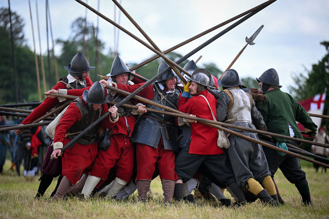 English Civil War Society reenactors recreate the Battle of Wimborne, on May 26, 2024 in Wimborne Minster, England. For the first time in Wimborne, the English Civil War Society re-enacts the 17th century Battle of Wimborne, with over 600 members featuring foot soldiers, cavalry, and a military camp. The English Civil War Society's reenactment culminates in two large battles between the Royalists and the Parliamentarians. (Photo by Finnbarr Webster/Getty Images)