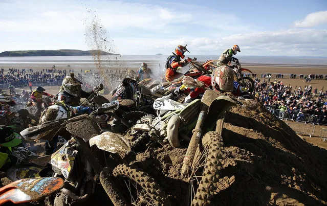 Riders attempt to reach the summit of a dune as they compete in the Adult Solo race at the HydroGarden Weston Beach Race in Weston- super- Mare, south west England, on October 9, 2016. (Photo by Adrian Dennis/AFP Photo)
