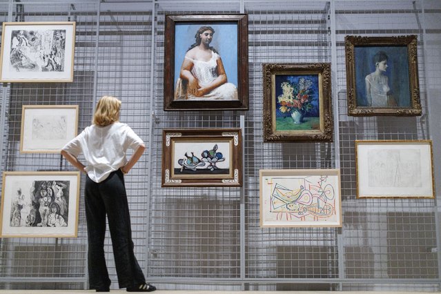 A visitor looks at the artworks by Spanish artist Pablo Picasso during the press preview of the new exhibition “Theatre Picasso” at Tate Modern in London, Britain, 15 September 2025. The exhibition explores Picasso's fascination with performers, dancers, entertainers, and bullfighters that he painted, and it runs from 17 September 2025 to 12 April 2026. (Photo by Tolga Akmen/EPA)